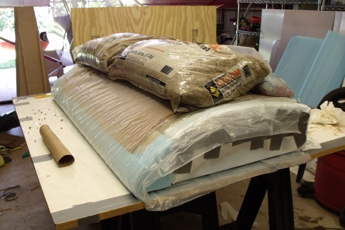 Core_with_inside_skin_attached_and_weighted_up_to_cure.jpg